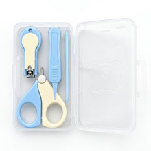 A baby nail care set in a clear plastic storage case, featuring light blue and cream-colored tools including nail clippers, nail scissors, a nail file, and a small spatula, shown on a white background.