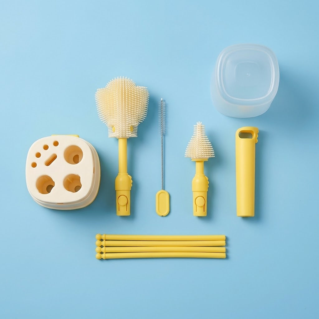 A baby bottle cleaning set arranged on a light blue background, including a clear plastic bottle lid, a beige silicone bottle brush, a yellow bottle brush, a metal cleaning brush, a yellow bottle opener, a beige silicone holder, and several yellow straw-like pieces.