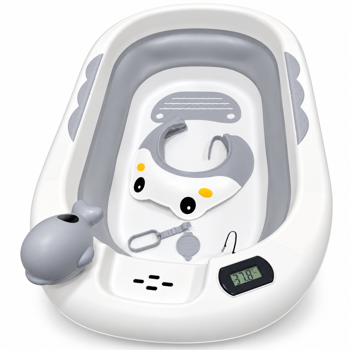 A baby bath tub set with a white exterior, gray interior, and included accessories including a whale-shaped handheld shower attachment, a small digital thermometer, and a gray and white baby head support seat with cartoon eyes.