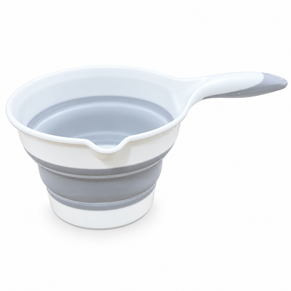 A collapsible silicone measuring cup with a handle, shown partially filled with water on a clean white background.