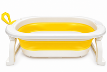A foldable baby bathtub with a white plastic frame and legs, a bright yellow interior, and a yellow carrying handle on the side, shown on a plain white background.