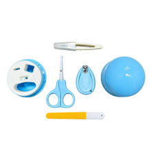 A baby nail care and grooming set arranged on a light blue background, including a small round blue-and-white container, a pair of blue-handled nail scissors, a nail clipper, a nail file, and a small round blue container.