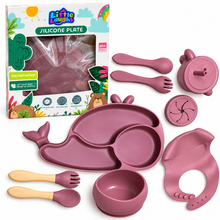 Little Radians Silicone Plate baby feeding set in dusty rose pink, including a whale-shaped divided plate, suction bowl, bib, sippy cup, utensils, and packaging box on a white background.